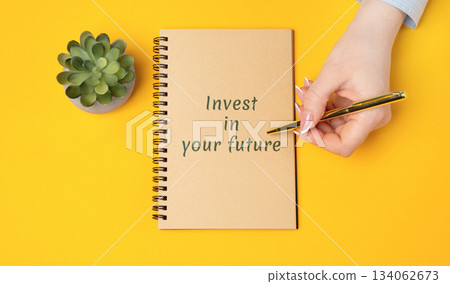 Notes Invest in your future concept. Financial growth, smart planning, and new opportunities. Real estate, business, investment, and motivational. Woman writing in a notepad 134062673