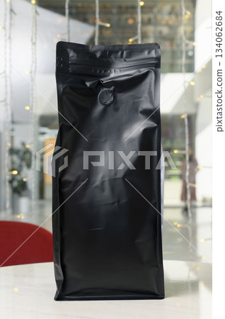 Vertical black matte coffee bag with flap on cafe table 134062684