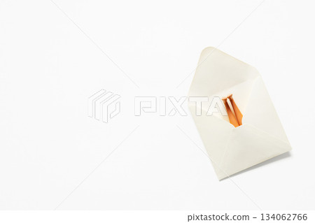 White paper envelope with doll legs sticking out on color of the year 2026 cloud white dancer background White paper envelope with doll legs sticking out on color of the year 2026 cloud white dancer background 134062766