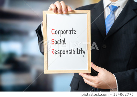 Corporate social responsibility. Concept of ethical business practices focused on sustainability, community support, transparency, and positive social and environmental impact. board in hands Corporate social responsibility. Concept of ethical business practices focused on sustainability, community support, transparency, and positive social and environmental impact. board in hands 134062775