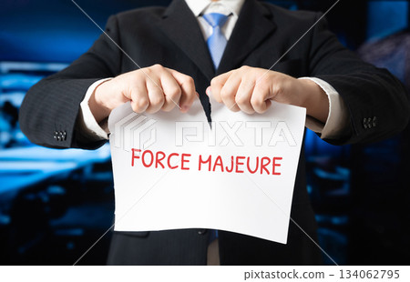 Businessman tearing a sheet of paper with the word Force majeure. 134062795