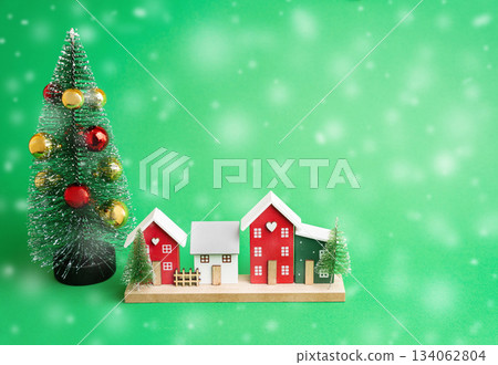 Miniature houses and Christmas trees. Merry Christmas and Happy New Year! Festive preparing for the xmas holidays. Town, city, real estate concept. Copy space Miniature houses and Christmas trees. Merry Christmas and Happy New Year! Festive preparing for the xmas holidays. Town, city, real estate concept. Copy space 134062804