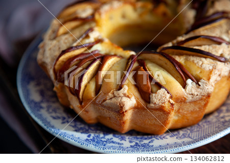 Round apple pie. Homemade pastries. Cupcake with apples on a wooden table. Simple food. 134062812