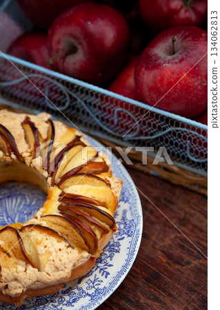 Round apple pie. Homemade pastries. Cupcake with apples on a wooden table. Simple food. 134062813