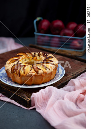 Round apple pie. Homemade pastries. Cupcake with apples on a wooden table. Simple food. 134062814