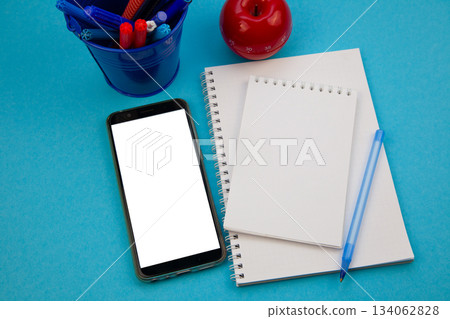 Mobile phone mockup background top view. Workplace copy space. Notepad, notebook and pen. Study and work. Planning. Self-learning. Online course. Education remotely. Cellphone Mobile phone mockup background top view. Workplace copy space. Notepad, notebook and pen. Study and work. Planning. Self-learning. Online course. Education remotely. Cellphone 134062828