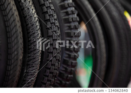 Bicycle tires in close-up. Tire texture. Black background. 134062840
