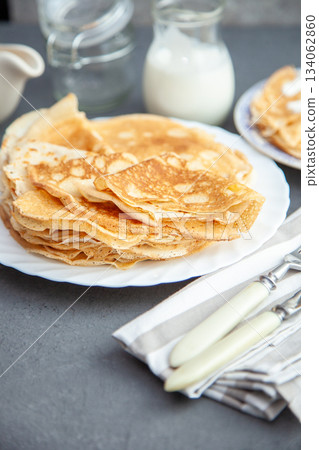 Thin pancakes. Floury food. Breakfast on the table. 134062860