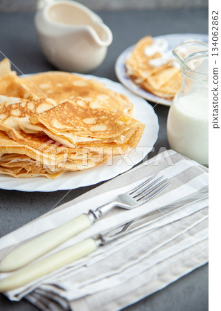 Thin pancakes. Floury food. Breakfast on the table. 134062862
