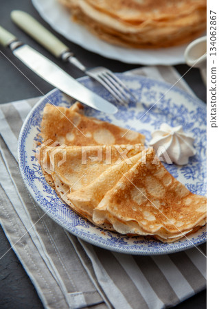 Thin pancakes. Floury food. Breakfast on the table. 134062867