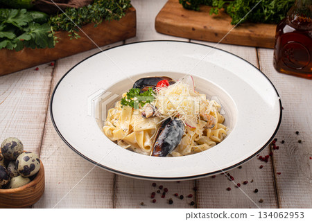 Creamy pasta with mussels and cheese Creamy pasta with mussels and cheese 134062953