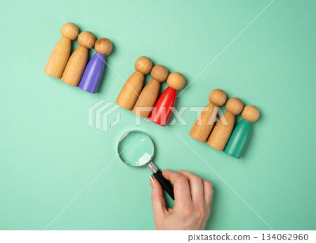 Market segmentation, target audience, customer groups, personalized marketing, and client relationship management strategies. Business. Woman looking through a magnifying glass people figurines Market segmentation, target audience, customer groups, personalized marketing, and client relationship management strategies. Business. Woman looking through a magnifying glass people figurines 134062960