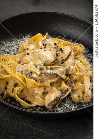 Creamy tagliatelle pasta with mushrooms 134062974