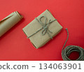 Packing of New Year's gifts Gift, twine, paper on a red background. 134063901
