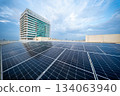 Solar Panel Photovoltaic installation on a Roof of factory, sunny blue sky background, alternative electricity source - Sustainable Resources Concept. 134063940