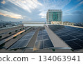 Solar Panel Photovoltaic installation on a Roof of factory, sunny blue sky background, alternative electricity source - Sustainable Resources Concept. 134063941