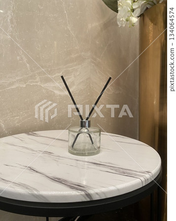 Clear reed diffuser on round marble side table Clear reed diffuser on round marble side table 134064574