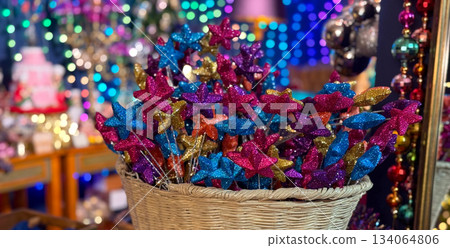 Banner Christmas Wicker basket filled with glitter star picks in bright holiday colors. Festive creative decor, Christmas craft charm, joyful winter celebration and magical party inspiration. 134064806