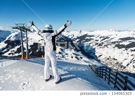 Woman skier enjoying the slopes view in Kaprun, austria alps, freedom, and winter sports 134065305
