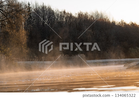 Golden Sunrise Over a Misty Lake in Autumn, Serene Landscape Reflection, Nature s Beauty 134065322