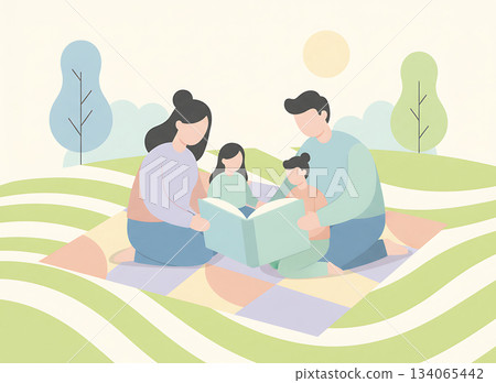Family is reading a book together during sunny day picnic in the park 134065442
