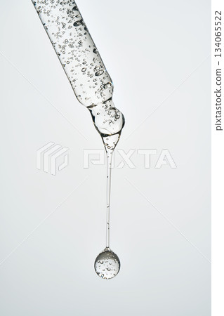 Cosmetic pipette dispensing serum bubble for skincare routine Cosmetic pipette dispensing serum bubble for skincare routine 134065522