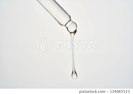Cosmetic pipette dispensing transparent serum drop 134065523