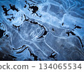winter background shapes on frozen water surface 134065534