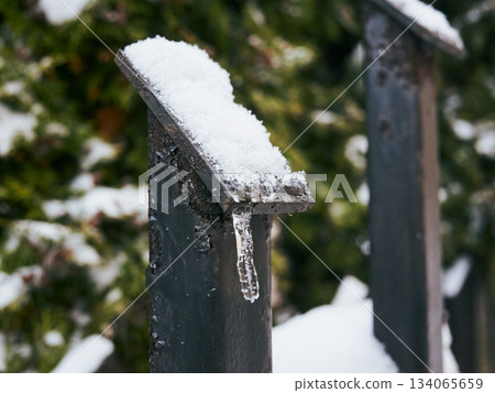 Closeup of icy ornament on metal fence in winter ambiance 134065659