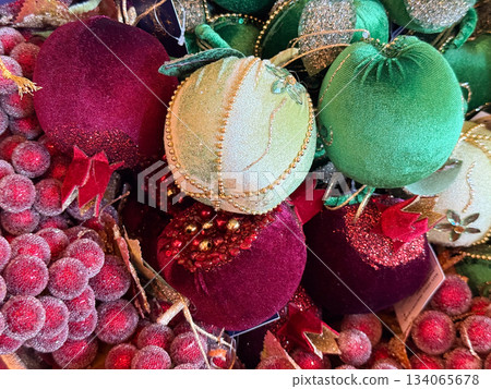 Velvet baubles and frosted berries arranged in festive holiday assortment. Christmas luxury, rich textile decor, winter ornament craft and seasonal celebration atmosphere 134065678
