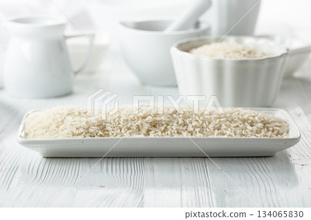 Raw organic rice in white dish. 134065830