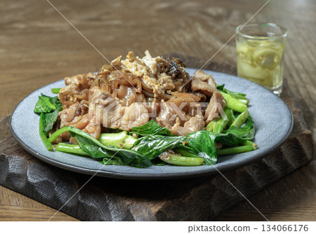 Stir-fried wide rice noodles (Pad See Ew) featuring wide rice noodles, stir-fried with a Thai omelet, marinated pork and Chinese kale. Stir-fried wide rice noodles (Pad See Ew) featuring wide rice noodles, stir-fried with a Thai omelet, marinated pork and Chinese kale. 134066176