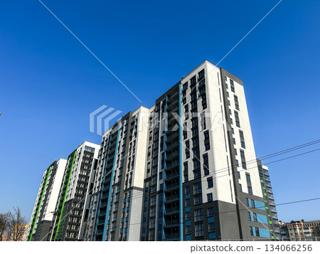 Modern newly built residential apartment building. Multi story apartment complex with fresh facade. Urban development and modern living concept. Horizontal, high quality. Modern newly built residential apartment building. Multi story apartment complex with fresh facade. Urban development and modern living concept. Horizontal, high quality. 134066256