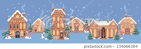 Cute gingerbread village with snowy cookie houses, winter trees and falling snow on a blue night background. Ideal for holiday illustrations and greeting cards 134066304