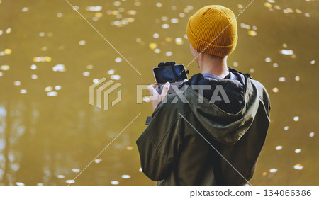 Man Filmmaker Viewing Camera Feed from Drone Man Filmmaker Viewing Camera Feed from Drone 134066386