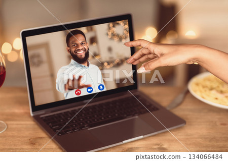 Long Distance Relationship. African american couple having online virtual date, reaching hands to each other to webcam in videochat with videoconferencing app window. Remote Dating During Pandemic. Long Distance Relationship. African american couple having online virtual date, reaching hands to each other to webcam in videochat with videoconferencing app window. Remote Dating During Pandemic. 134066484