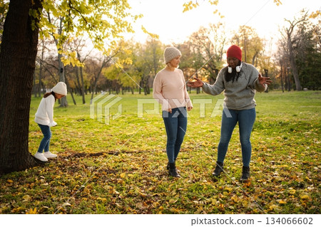 Diverse adult women and child talking in autumn park 134066602