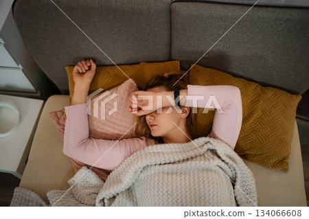 Woman sleeping on sofa feeling tired and stressed 134066608