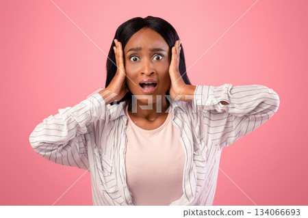 No way. Shocked black woman grasping her head in disbelief over pink studio background. Amazed African American lady emotionally reacting to news or offer, opening mouth in shock No way. Shocked black woman grasping her head in disbelief over pink studio background. Amazed African American lady emotionally reacting to news or offer, opening mouth in shock 134066693