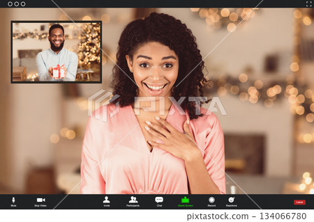 Celebration During Quarantine. Happy amazed black woman having online video call with her man, guy showing present gift box to his girlfriend at videochat. Screen view with conference app Celebration During Quarantine. Happy amazed black woman having online video call with her man, guy showing present gift box to his girlfriend at videochat. Screen view with conference app 134066780