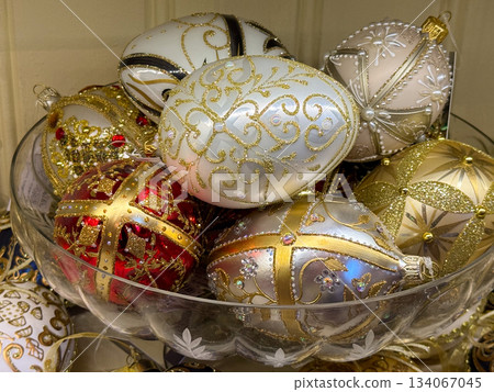 Gold and ivory Christmas ornaments with gems and embroidery gathered in glass bowl. Luxury holiday decor, festive elegance, winter celebration craft and traditional ornament collection Gold and ivory Christmas ornaments with gems and embroidery gathered in glass bowl. Luxury holiday decor, festive elegance, winter celebration craft and traditional ornament collection 134067045