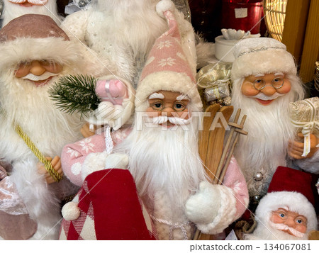 Pink Santa with skis in winter market display bringing soft festive nostalgia and fairytale warmth Pink Santa with skis in winter market display bringing soft festive nostalgia and fairytale warmth 134067081