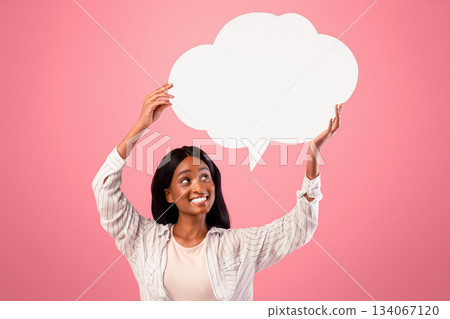 Positive African American woman with blank speech bubble on pink studio background, space for design. Lovely black lady with empty word box, mockup for your advertisement Positive African American woman with blank speech bubble on pink studio background, space for design. Lovely black lady with empty word box, mockup for your advertisement 134067120