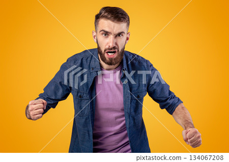 Portrait of young angry man shouting with rage, clenching fists on grey studio background. Furious Caucasian guy screaming with anger, expressing his frustration, ready for fight or conflict Portrait of young angry man shouting with rage, clenching fists on grey studio background. Furious Caucasian guy screaming with anger, expressing his frustration, ready for fight or conflict 134067208