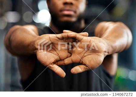 Hands in lock of unrecognizable black guy sportsman stretching hands and fingers in gym, closeup, panorama. Cropped of african american young man bodybuilder warming up before exercising 134067272