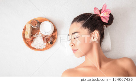 Asian Woman Relaxing During Aromatherapy Session With Natural Cosmetics In Beauty Spa, Lying On Massage Table With Closed Eyes, Enjoying Body Care And Self-Pampering, Top View With Free Space Asian Woman Relaxing During Aromatherapy Session With Natural Cosmetics In Beauty Spa, Lying On Massage Table With Closed Eyes, Enjoying Body Care And Self-Pampering, Top View With Free Space 134067426