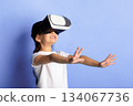Cyberspace Concept. Happy asian kid wearing VR helmet, experiencing virtual reality, turquoise studio wall Cyberspace Concept. Happy asian kid wearing VR helmet, experiencing virtual reality, turquoise studio wall 134067736