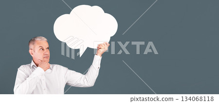 I Think. Pensive senior man looking at blank speech bubble, touching his chin, copyspace, blue studio wall I Think. Pensive senior man looking at blank speech bubble, touching his chin, copyspace, blue studio wall 134068118