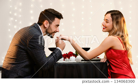 Gallant Man Kissing Hand Of His Pleased Girfriend On Romantic Date In Restaurant 134068300