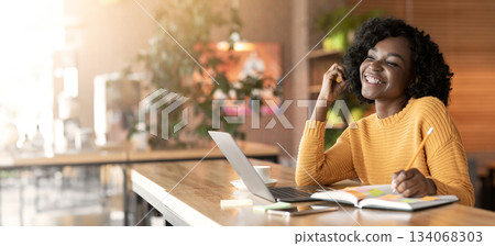 Young afro woman dreaming about successful career, looking for job online, using laptop, empty space 134068303